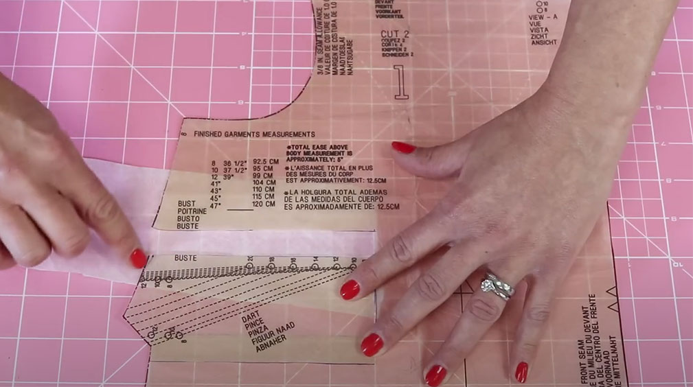 Sewing pattern piece with gap from moved dart filled in with tissue paper